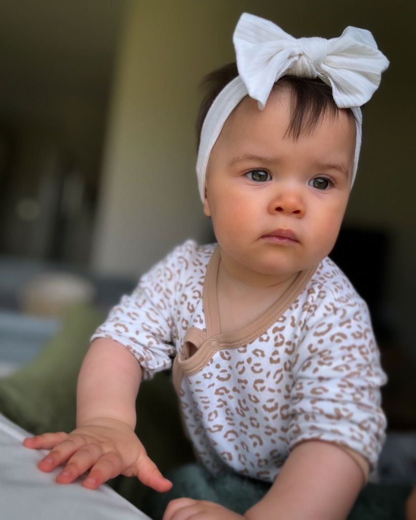 baby girl wearing a white hair bow