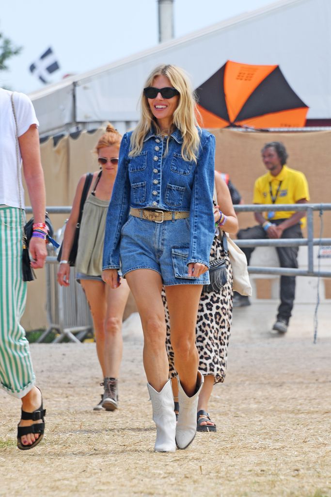 Sienna Miller in a double denim jacket and mini shorts at Glastonbury Festival