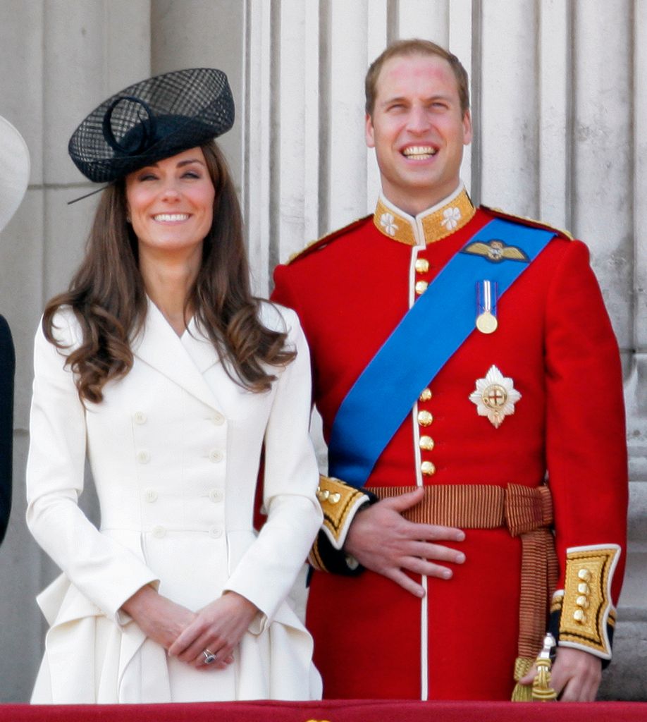 Catherine, Duchess of Cambridge and Prince William, Duke of Cambridge stand on the balcony of Buckingham Palace following the Trooping the Colour parade on June 11, 2011 in London, England. 
