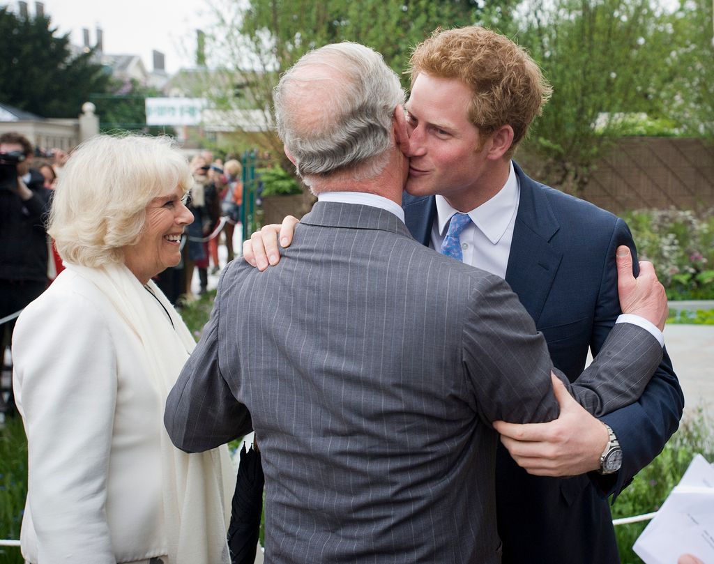 Prince Harry hugs his father Charles