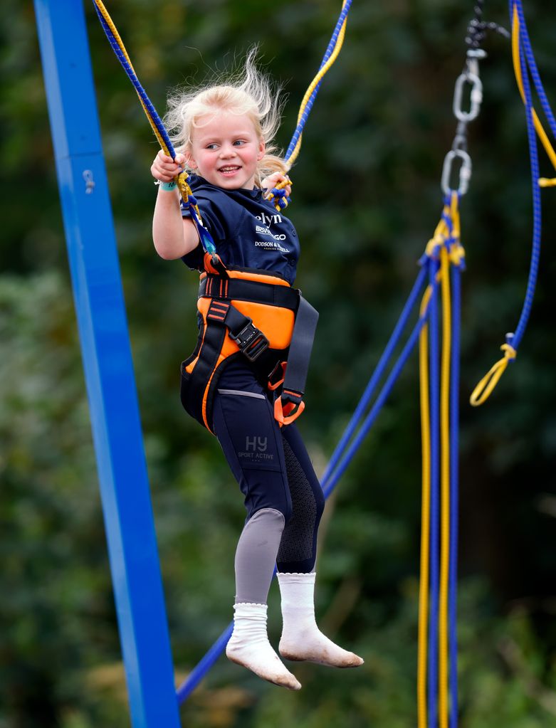 Lena Tindall plays on the bungee trampoline while attending the first day of the 2023 Festival of British Eventing at Gatcombe Park