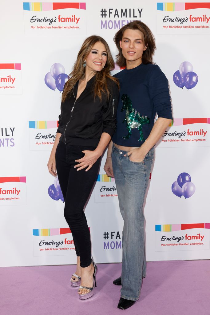 Mother and son posing on the purple carpet 