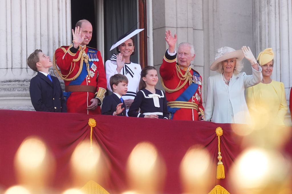 Members of the royal family are waving from the balcony of the palace
