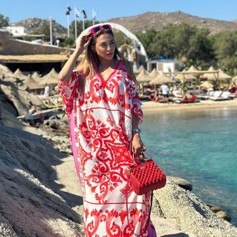 Farah El Kadi in a red and white kimono on the rocks by the sea