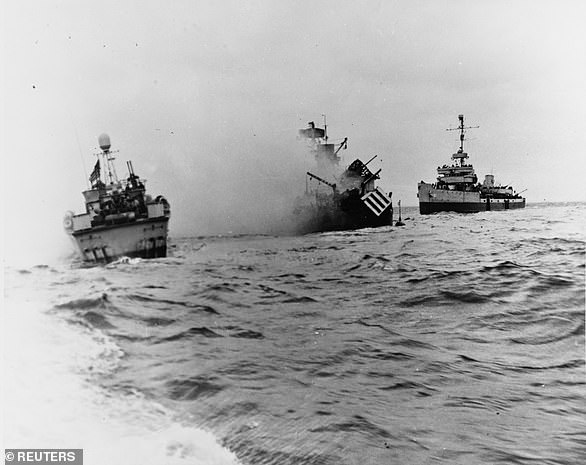 The US Navy minesweeper USS Tide sinks after striking a mine, while its crew are assisted by patrol torpedo boat PT-509 and minesweeper USS Pheasant. When another ship attempted to tow the damaged ship to the beach, the strain broke her in two and she sank only minutes after the last survivors had been taken off