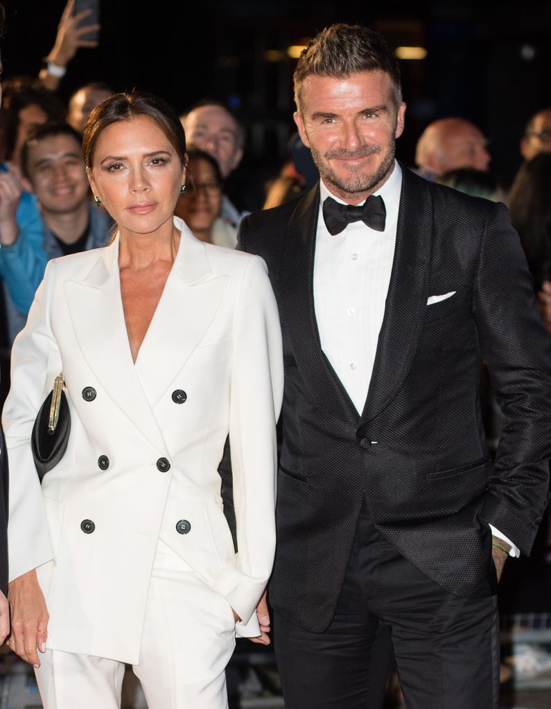 Victoria and David Beckham in white suits and tuxedos