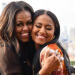Michelle Obama’s daughter Sasha, 23, rocks rainbow heels as she poses at rooftop bar with famous mom on bittersweet day