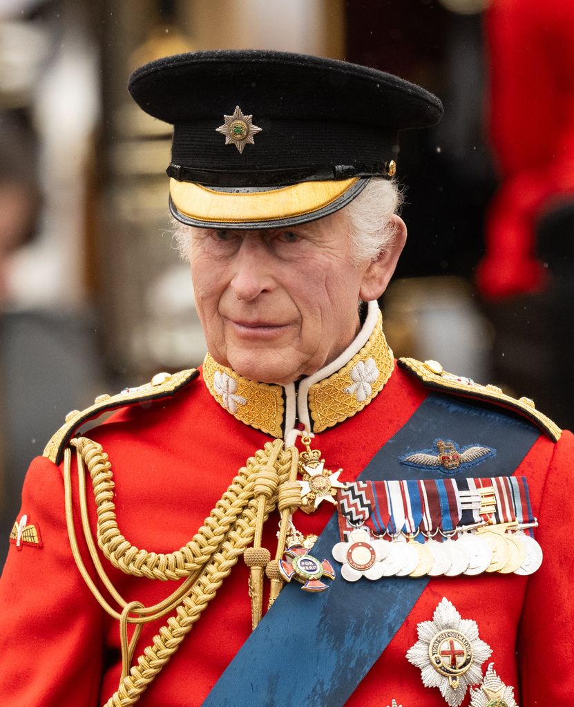 King Charles smiling at soldiers in military uniform