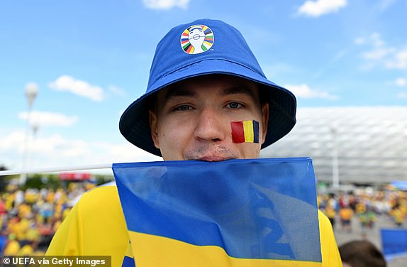 MUNICH, GERMANY - JUNE 17: A Romania fan wearing a bucket hat and face paint in the colours of the national flag poses while enjoying the pre-match atmosphere ahead of the UEFA EURO 2024 group stage match between Romania and Ukraine at the Munich Football Arena on June 17, 2024 in Munich, Germany. (Photo by Chris Rico - UEFA/UEFA via Getty Images)