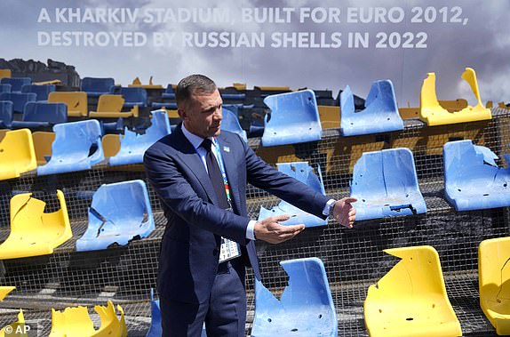 Ukrainian football legend and UAF president Andriy Shevchenko presents an installation ahead of the Group E match between Romania and Ukraine at the Euro 2024 football tournament in Munich, Germany, Monday, June 17, 2024. A poignant installation has been unveiled ahead of Ukraine's first match at the European Championship. A destroyed stand from Kharkiv's Sonyachny Stadium, which was built for Euro 2012, is on display in a square in Munich ahead of the team's opener against Romania. (AP Photo/Ariel Shalit)