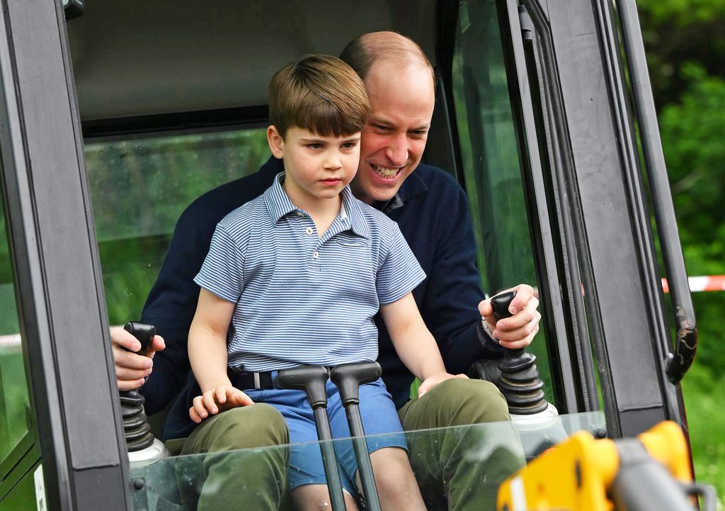 Prince Louis sitting in a tractor with Prince William