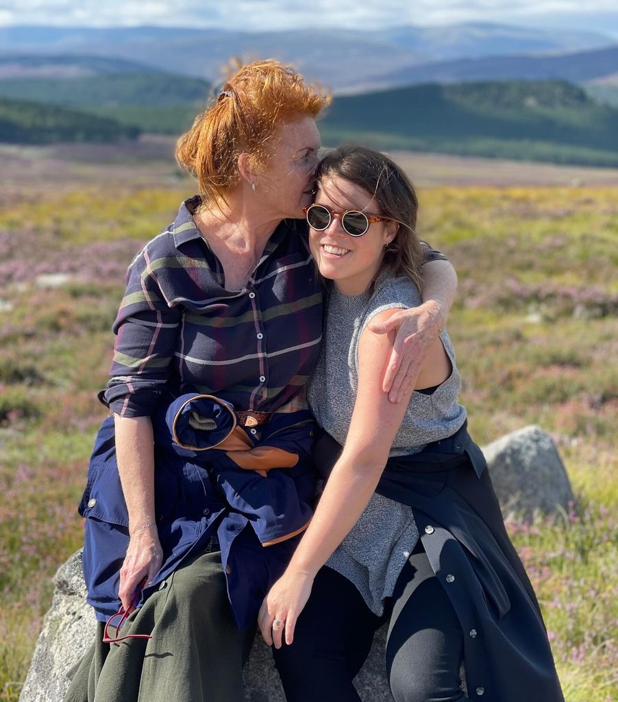 Sarah Ferguson with Princess Eugenie in her arms in the countryside