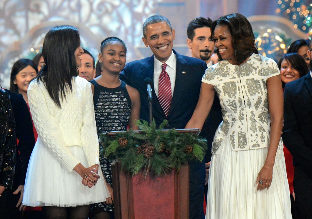 Malia Obama, Sasha Obama, U.S. President Barack Obama and First Lady Michelle Obama on stage at TNT's Christmas in Washington 2013 held at the National Building Museum in Washington, DC on December 15, 2013.
