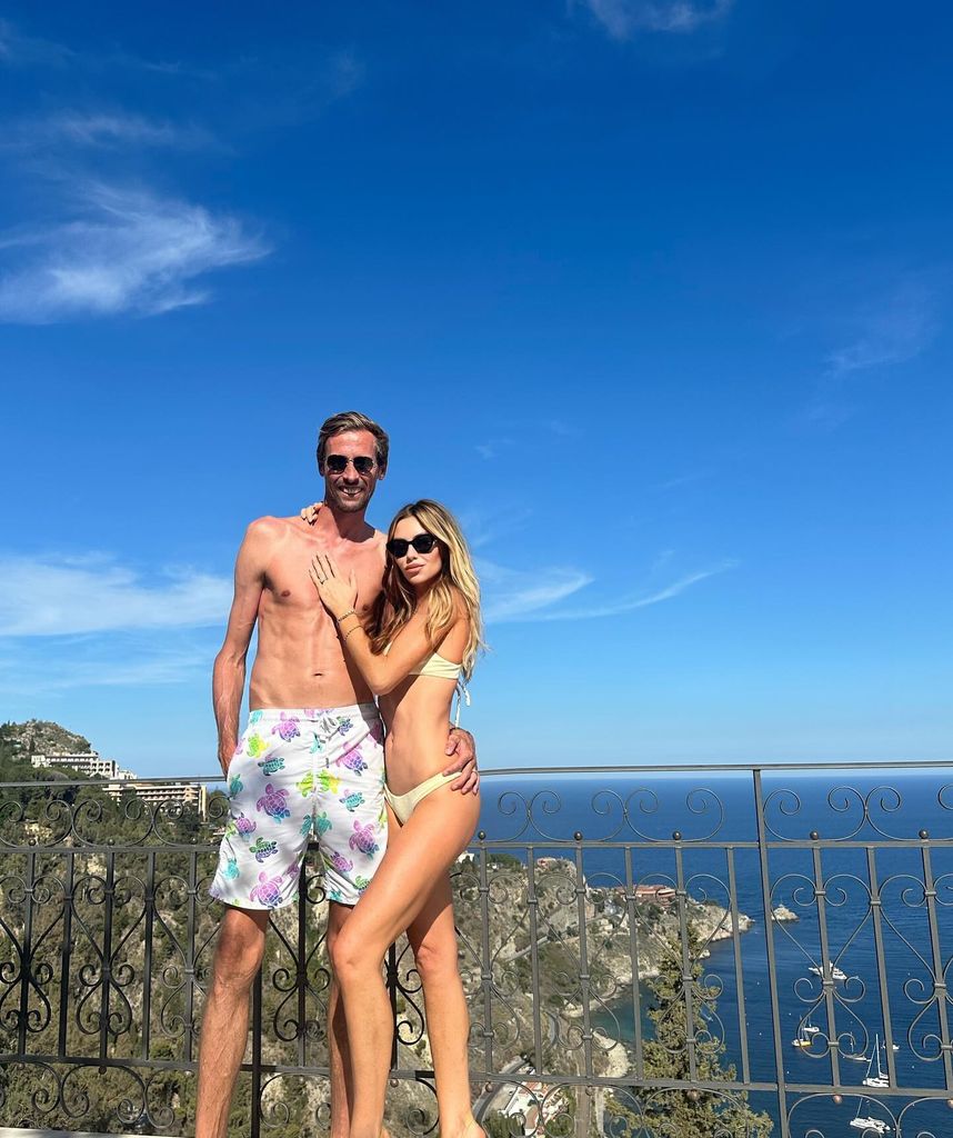 Abbey Clancy in a white bikini and Peter Crouch shirtless in swimming trunks