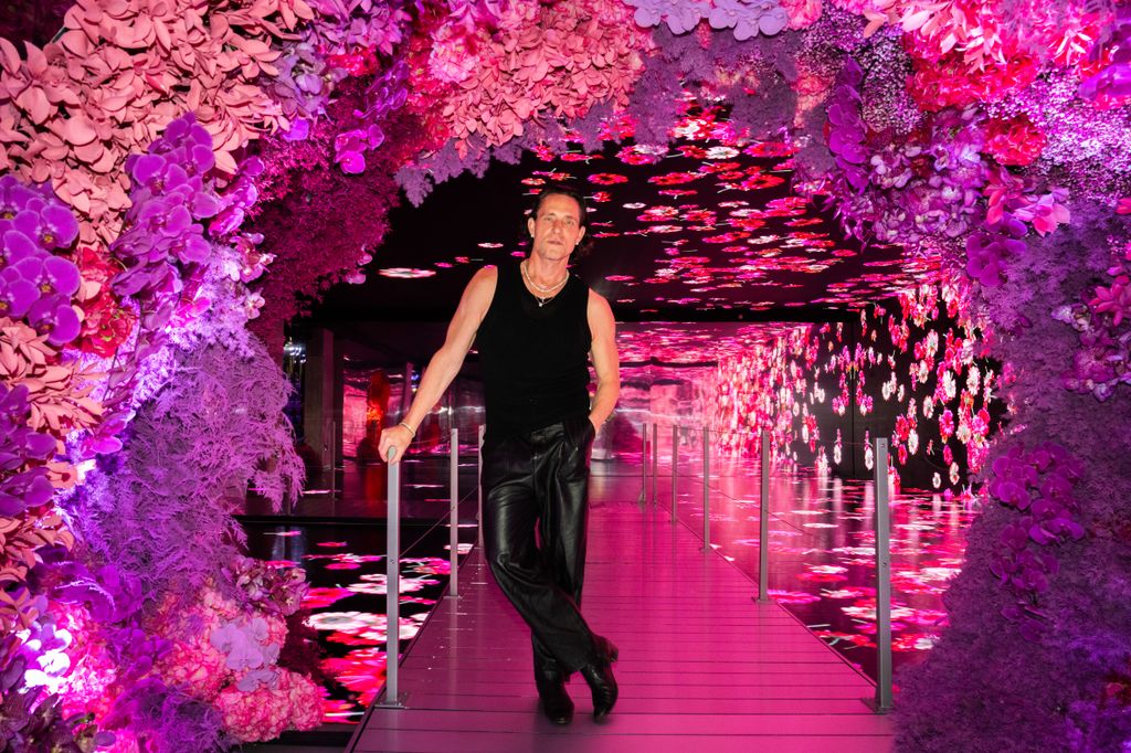 Jeff Latham posing inside Bloomtechnica, an immersive floral experience Genesis House NYC 