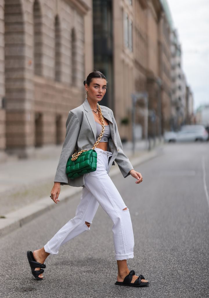 Celine Bethmann wears white Levis with a pair of chunky black sandals