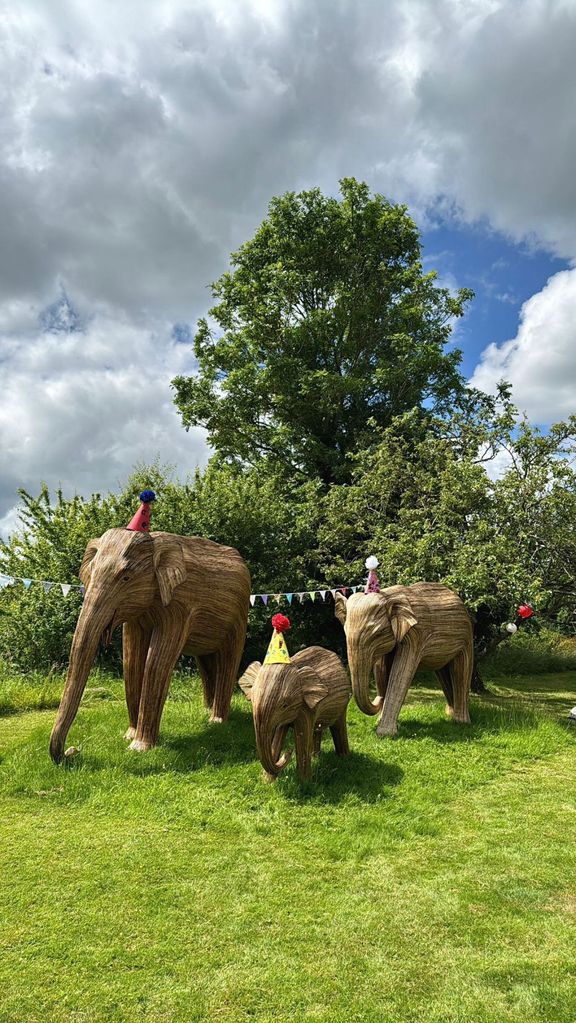 Photo of elephant statues wearing party hats