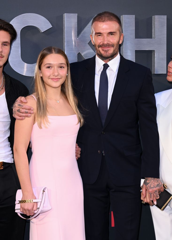 Harper Beckham standing with David