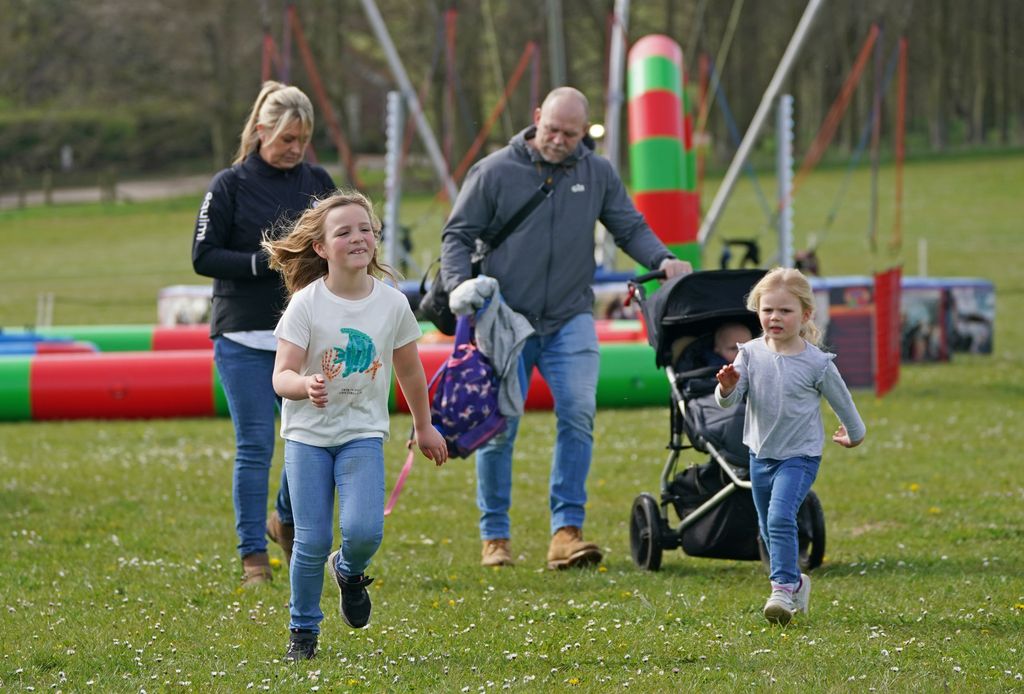 Mike Tindall with his children Mia (left), Lena Elizabeth (right) and Lucas on the grass at Barefoot Retreats Burnham Market International Horse Trials