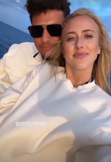 Patrick and Brittany Mahomes in white outfits on a boat
