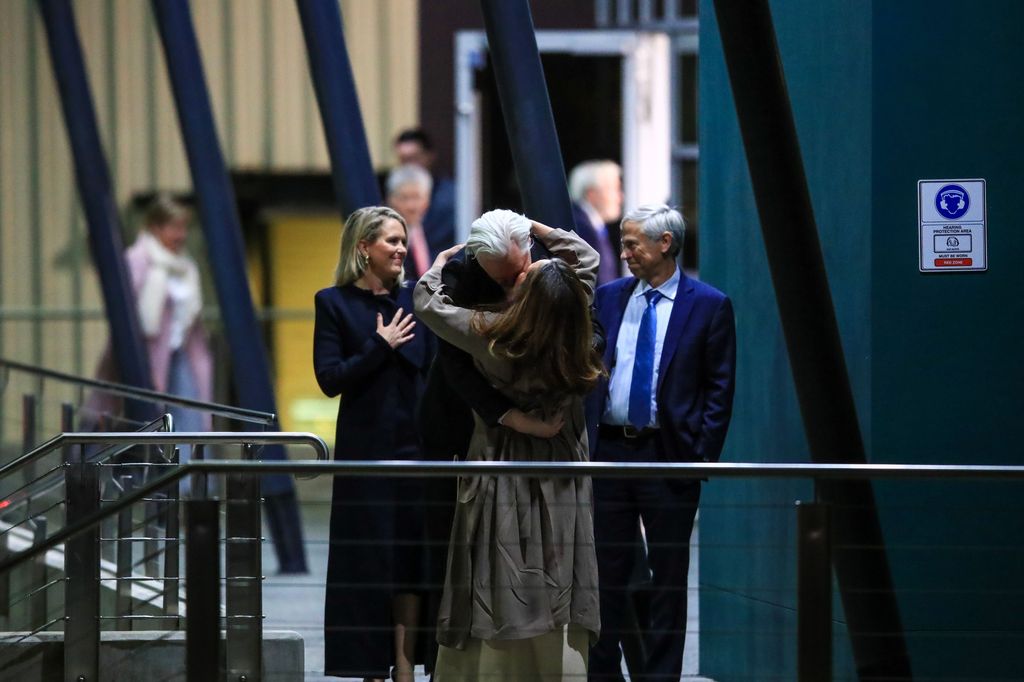 WikiLeaks founder Julian Assange kisses his wife Stella Assange as he arrives at Canberra Airport 