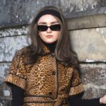 Maisie Williams looks unrecognisable as she ditches buzz cut for vampy 70s curls
