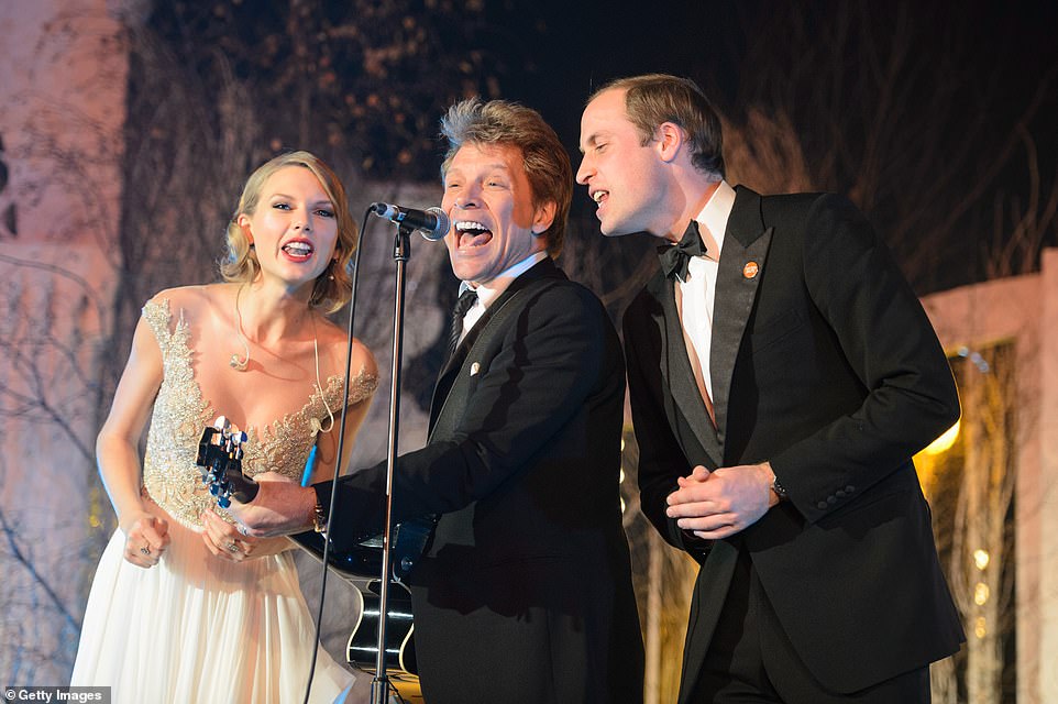 Taylor Swift, Jon Bon Jovi and Prince William are pictured singing Livin' On A Prayer on stage at the Centrepoint Gala Dinner at Kensington Palace in London on November 26, 2013 - after the royal obeyed 'like a puppy' her suggestion he join her