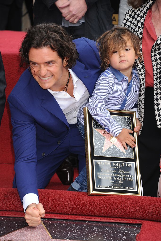 Orlando Bloom and his son Flynn pose at the ceremony in which he was awarded a star on the Hollywood Walk of Fame in 2014