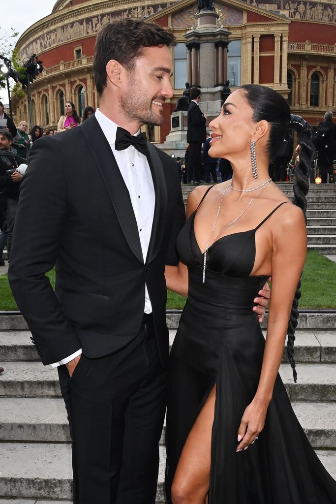Thom Evans and Nicole Scherzinger looking at each other