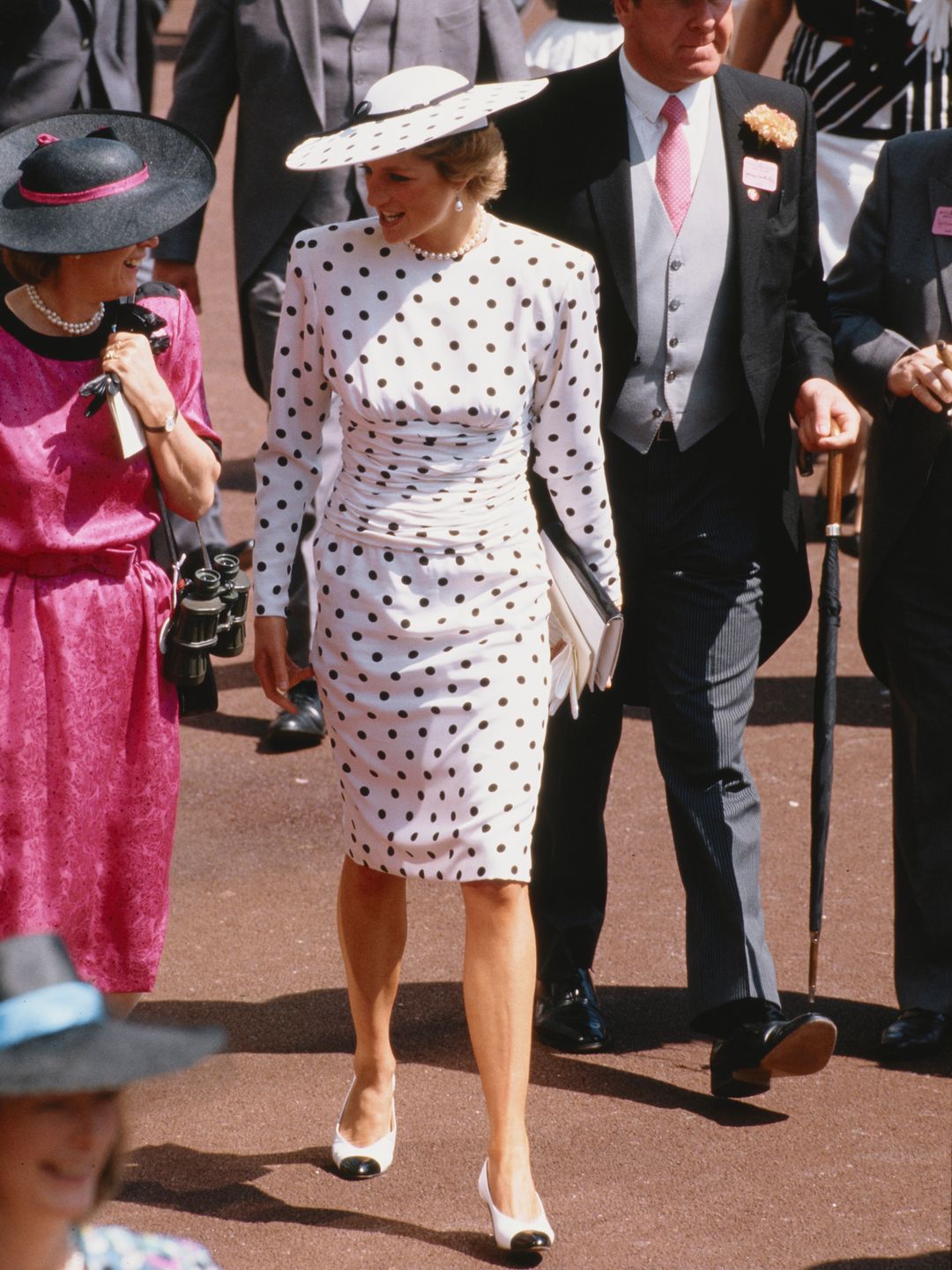 Diana, Princess of Wales, attends the Ascot race meeting in England in June 1988 wearing a black and white spotted dress designed by Victor Edelstein and a hat by Philip Somerville.  