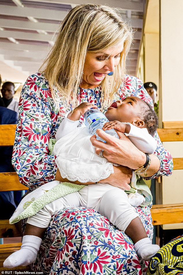 Queen Maxima gasps in faux shock as a young baby mimics her expression during a visit to a children's hospital in Tanzania in October 2022