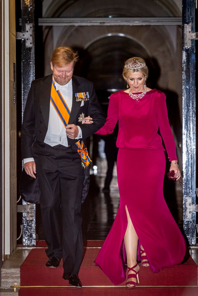 Queen Maxima in a burgundy gown, with King Willem