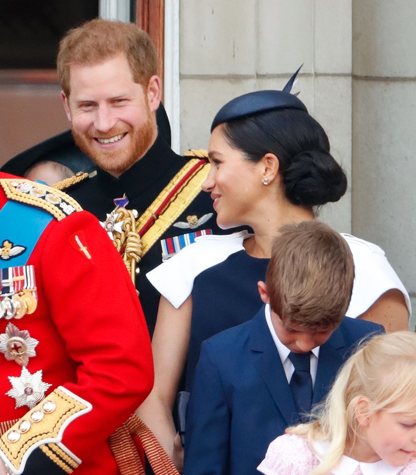 Harry and Meghan smiling on the balcony in 2019