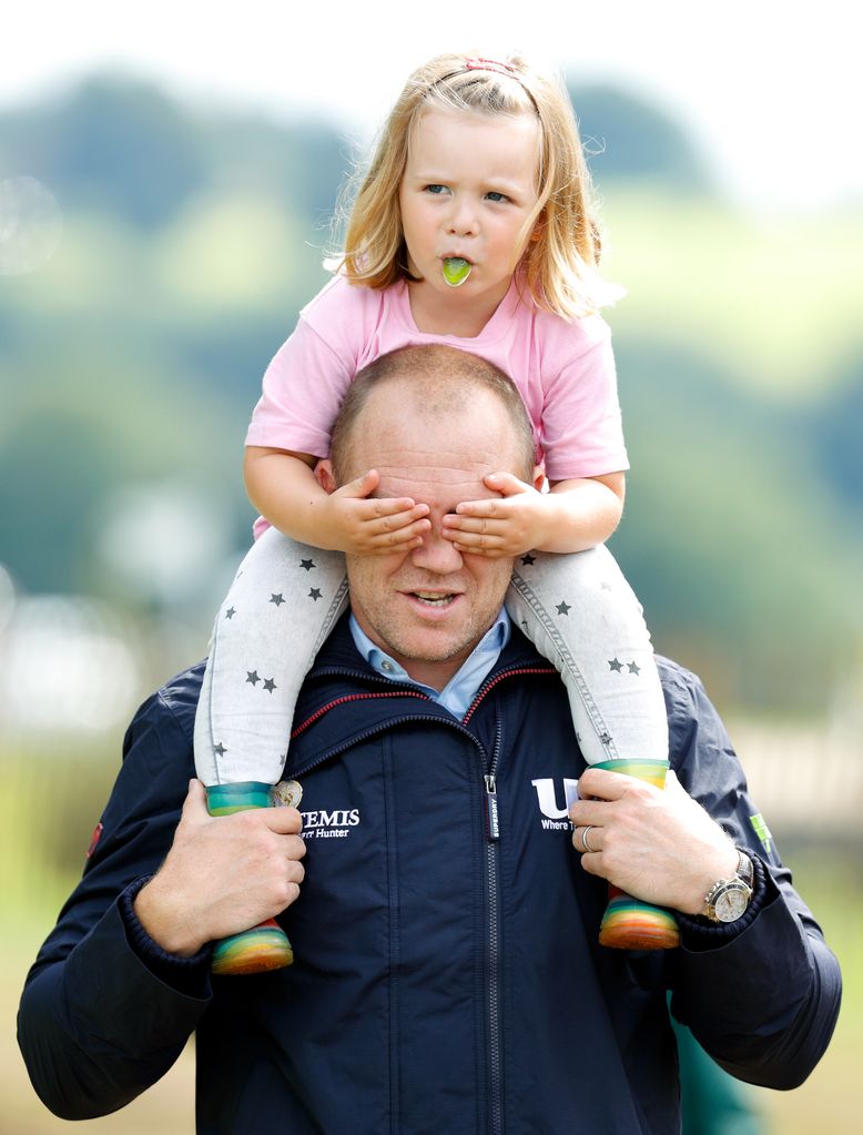 Mia Tindall riding on Mike Tindall's shoulders and covering his eyes