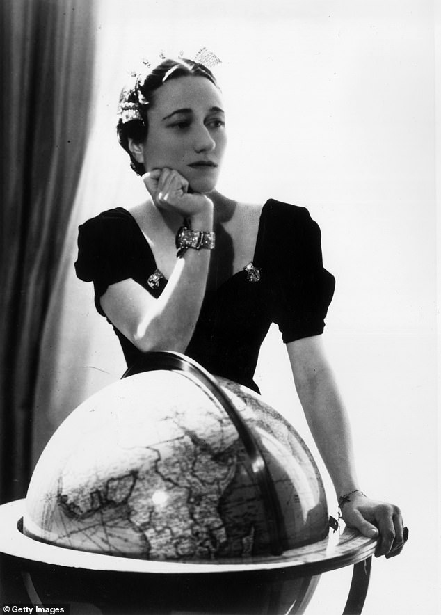 Wallis Simpson is seen in 1936 posing with her Cartier emerald engagement ring and a diamond and sapphire bracelet that was a gift from Edward