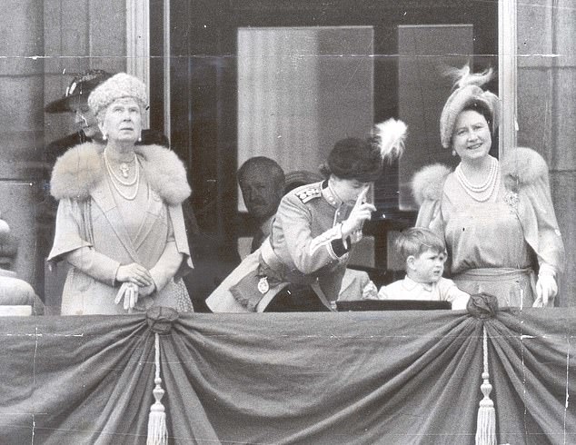 Princess Elizabeth (centre) tries to interest two-year-old Prince Charles by pointing to the planes overhead. Also pictured is her grandmother, Queen Mary and her mother, Queen Elizabeth