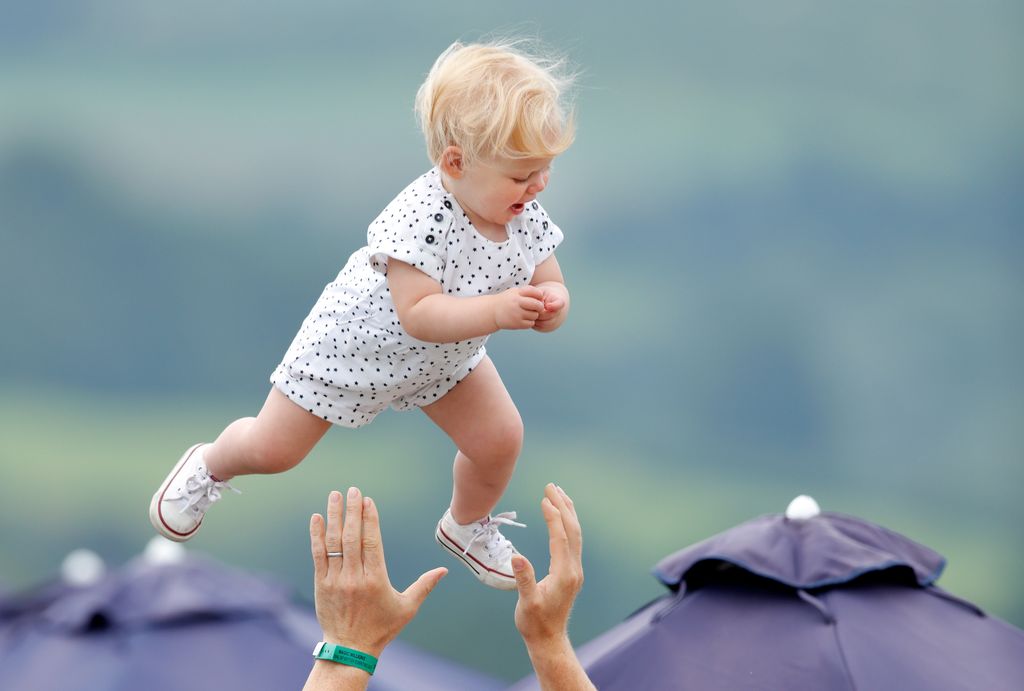 Mike Tindall throws daughter Lena Tindall into the air