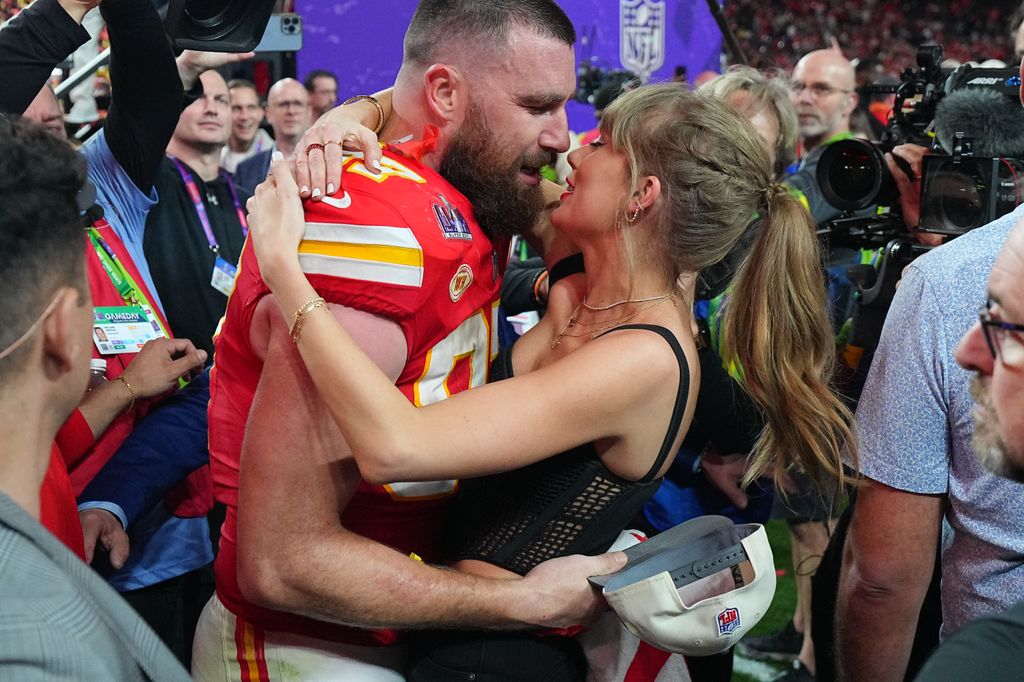 Kansas City Chiefs' Travis Kelce (87) kisses his girlfriend and singer Taylor Swift after win over San Francisco 49ers 