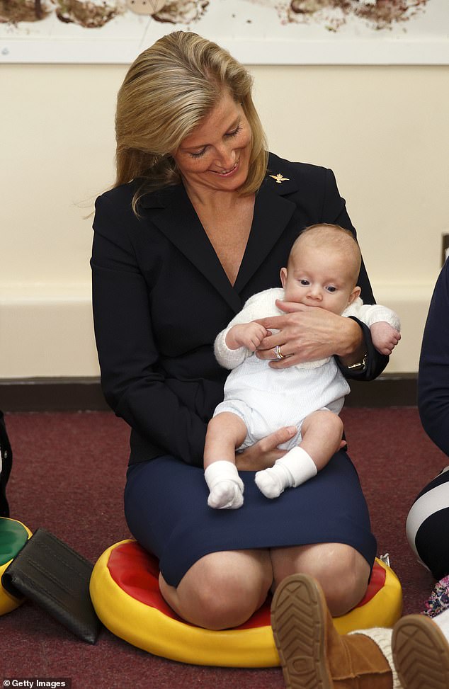 Sophie is besotted as she holds the hand of three-month-old Rowan Wilson-Jones  during a visit to RAF Wittering in September 2014