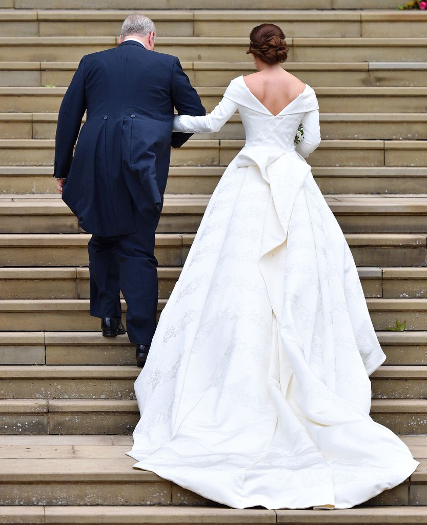 Prince Andrew and Princess Eugenie climbing the stairs before their royal wedding
