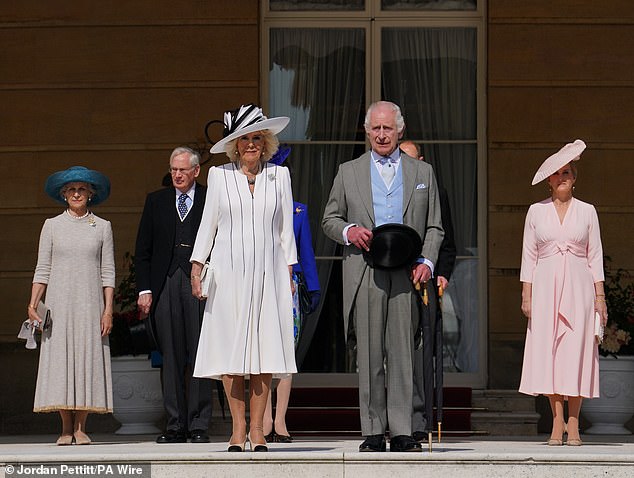 King Charles III and Queen Camilla stand with the Duke and Duchess of Edinburgh (right) and the Duke and Duchess of Gloucester (left) for the Buckingham Palace garden party today