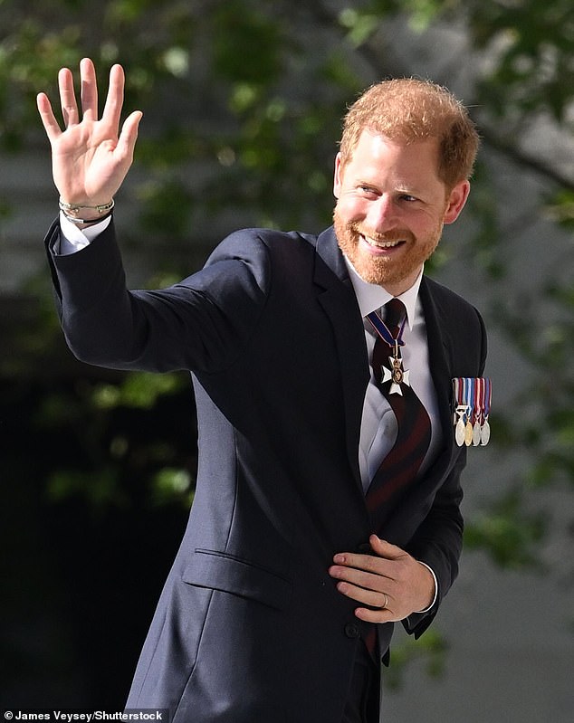 Prince Harry waves to veterans and royal watchers as he arrives at the ceremony