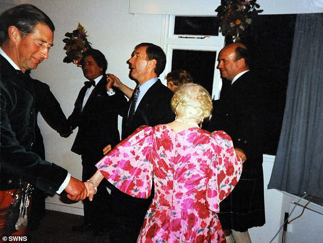 Prince Charles dances with the Queen Mother during a staff party at Birkhall