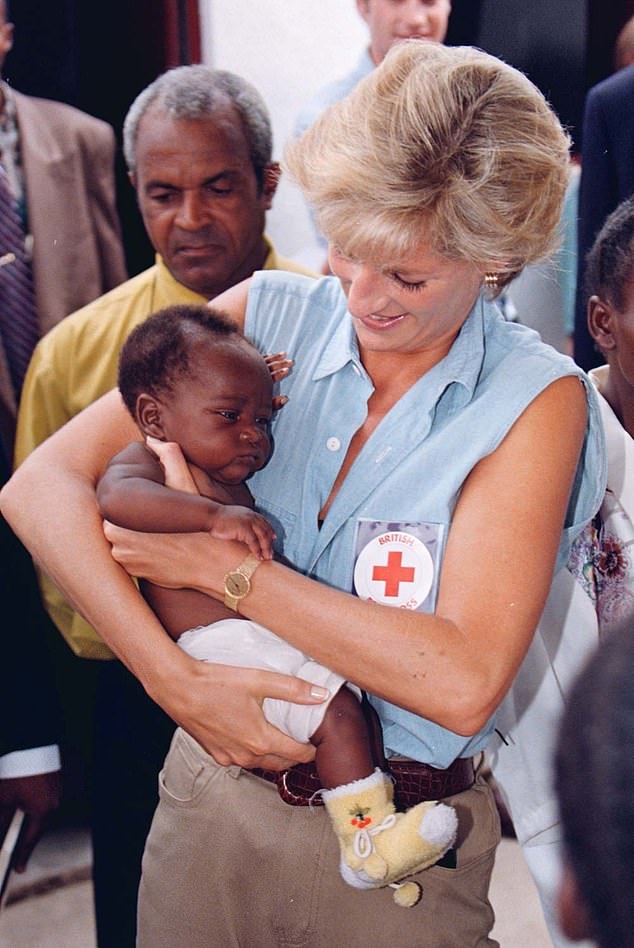 In 1997, Diana cradled a baby during a visit to a Red Cross unit in Angola that had been set up to help victims of land mines