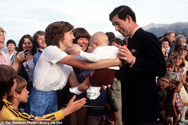 Prince Charles during a visit to New Zealand in April 1981 looks a little nervous as a mother passes him her baby