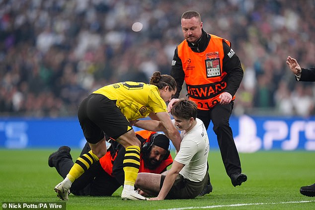 The match began with pitch invaders, with Dortmund midfielder Marcel Sabitzer knocking a player to the ground.