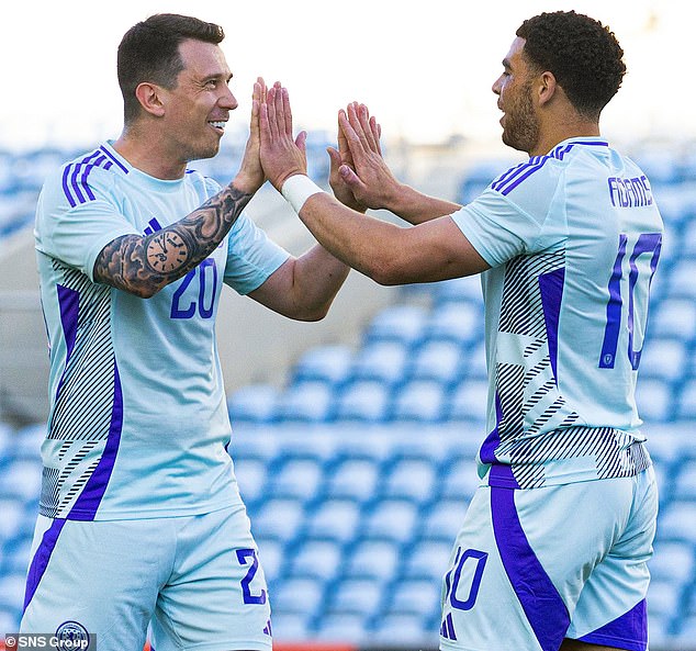 Che Adams (right) receives praise from Ryan Jack after doubling Scotland's lead