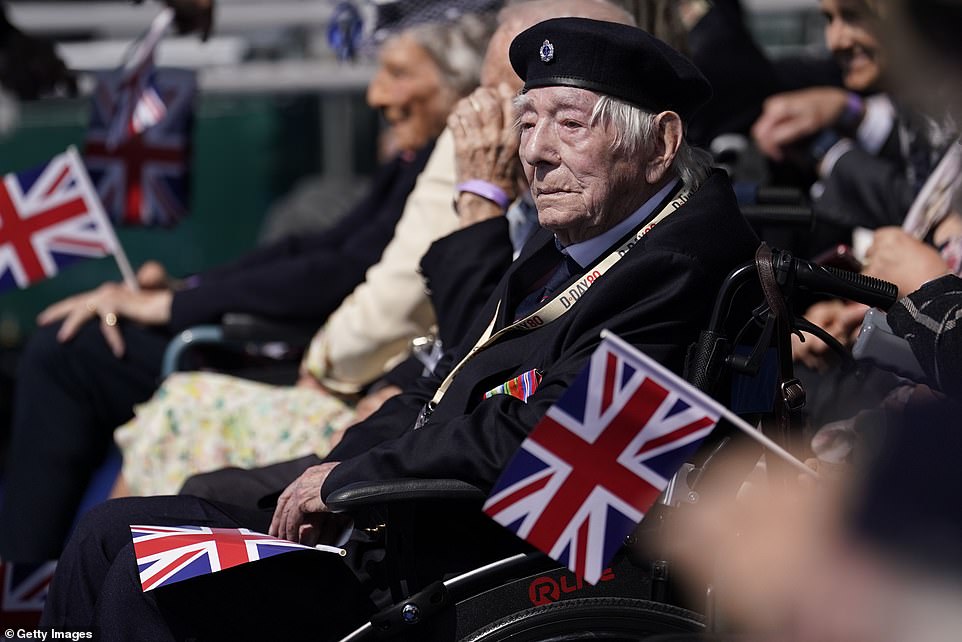 A Normandy veteran watches on as he prepares for the commemoration to begin