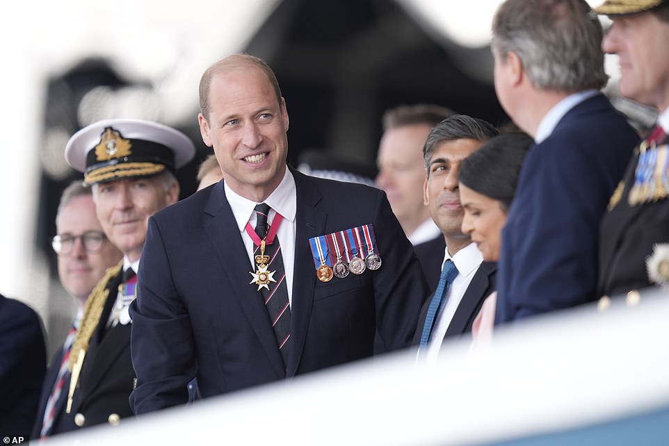 William smiles as he greets David Cameron - who was among the dignitaries in Portsmouth