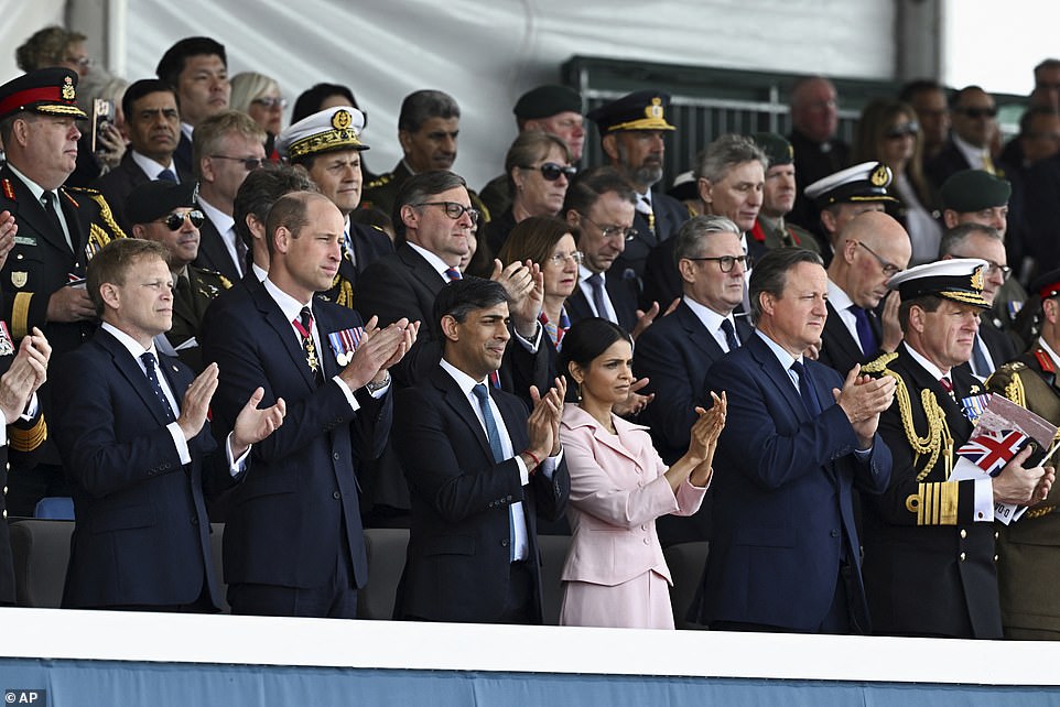 Members of the royal box stand and applaud at the start of this morning's ceremony